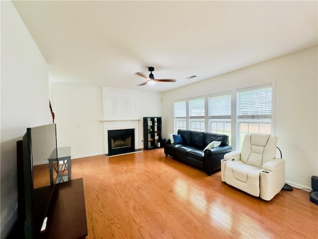 365 Friars Head Dr, Suwanee, GA 30024 - living room featuring ceiling fan, light wood-style floors, a fireplace, and baseboards