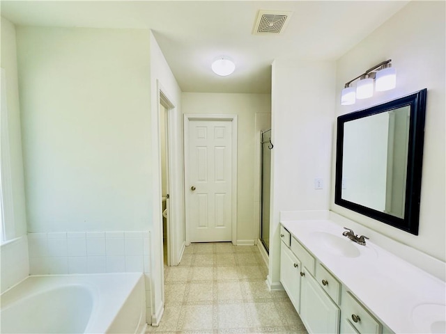 365 Friars Head Dr, Suwanee, GA 30024 - bathroom featuring tile patterned floors, double vanity, a garden tub, baseboards, and a stall shower
