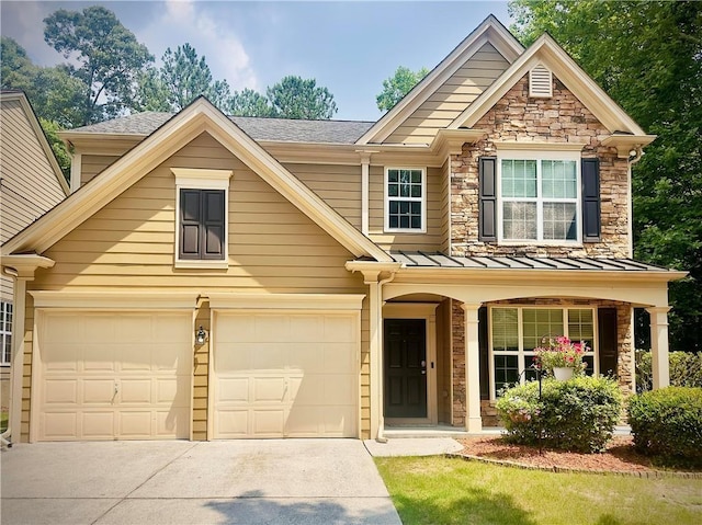 365 Friars Head Dr, Suwanee, GA 30024 - view of front facade with concrete driveway, a standing seam roof, stone siding, a garage, and a porch