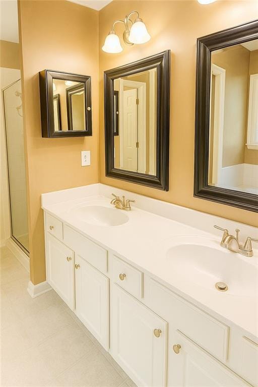 bathroom featuring tile patterned flooring, a sink, and double vanity