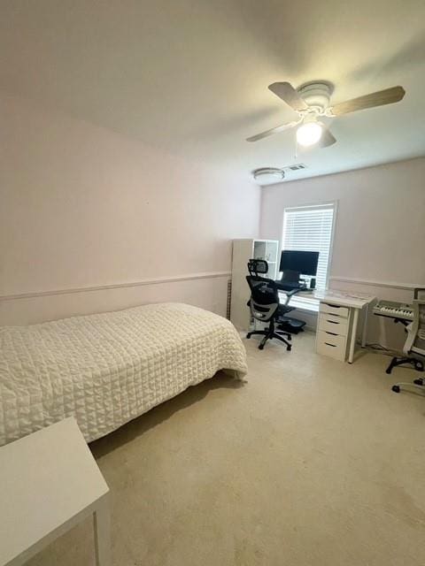 bedroom featuring visible vents, ceiling fan, and light carpet
