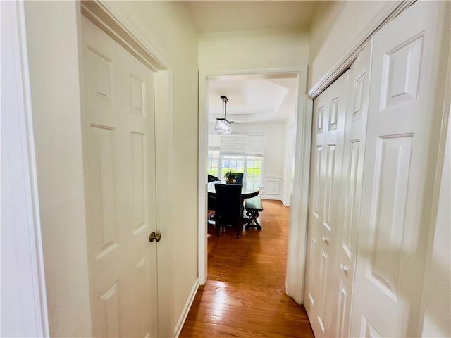 365 Friars Head Dr, Suwanee, GA 30024 - hallway with wood finished floors, a decorative wall, and wainscoting