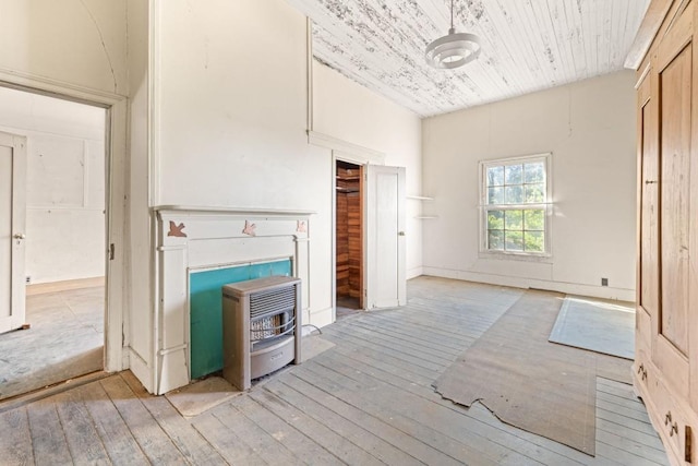 unfurnished living room with heating unit, light hardwood / wood-style flooring, and wooden ceiling