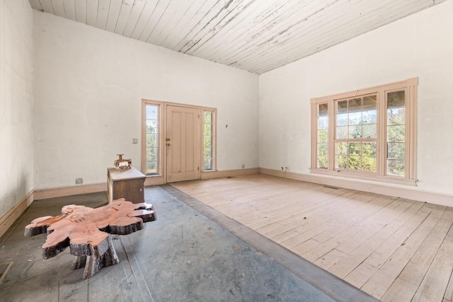 entrance foyer featuring light wood-type flooring and wood ceiling