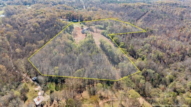 aerial view featuring a wooded view