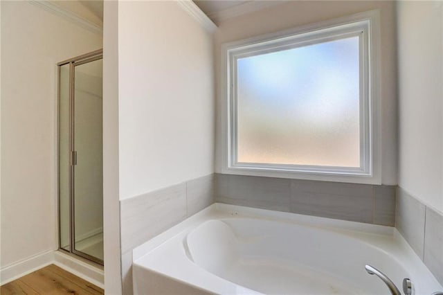 bathroom with ornamental molding, independent shower and bath, and wood-type flooring