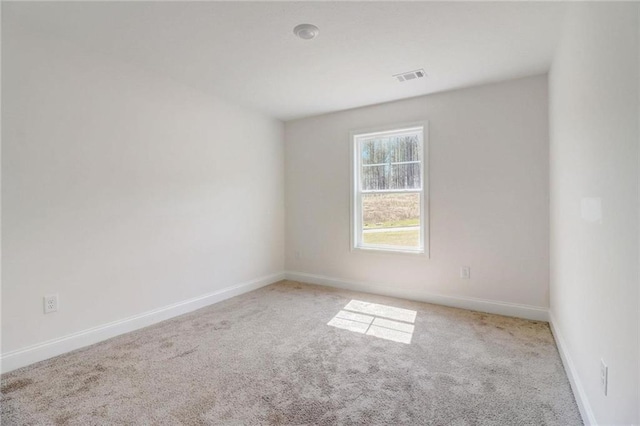 unfurnished room with light colored carpet