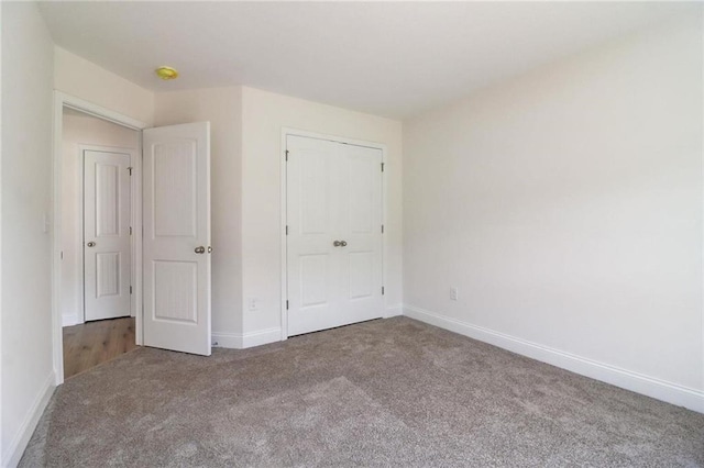 unfurnished bedroom featuring carpet and a closet