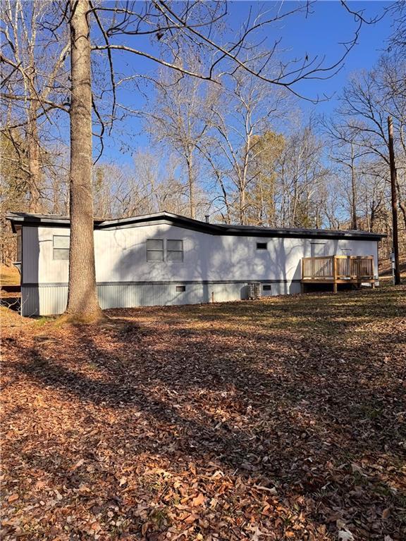 view of side of property with a wooden deck