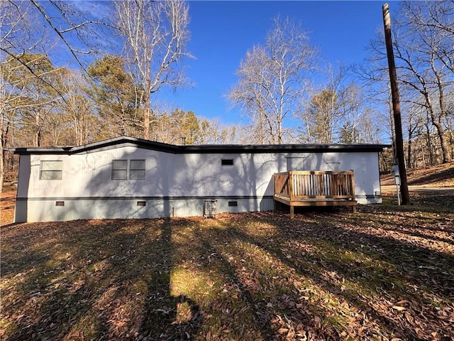 rear view of house featuring a wooden deck