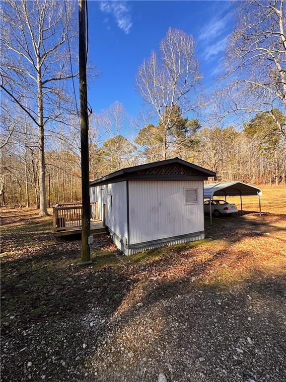 exterior space with a carport and a deck