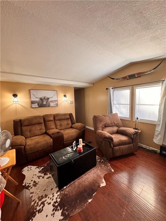 living room with vaulted ceiling, dark wood-type flooring, and a textured ceiling