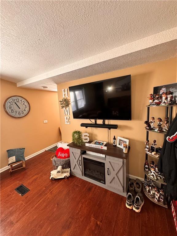 living room with hardwood / wood-style flooring and a textured ceiling