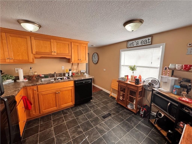 kitchen featuring dark stone countertops, sink, and black appliances