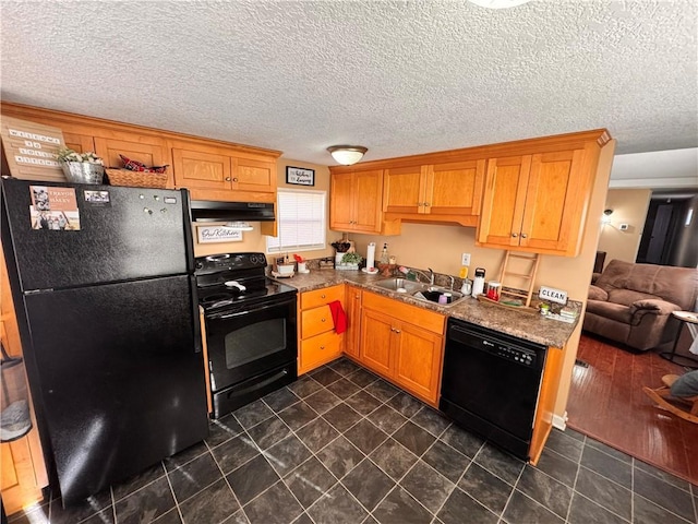 kitchen featuring a textured ceiling, sink, exhaust hood, and black appliances