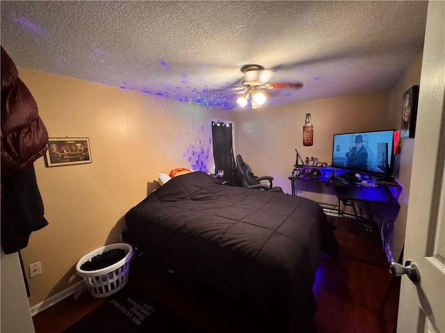 bedroom with a textured ceiling and ceiling fan