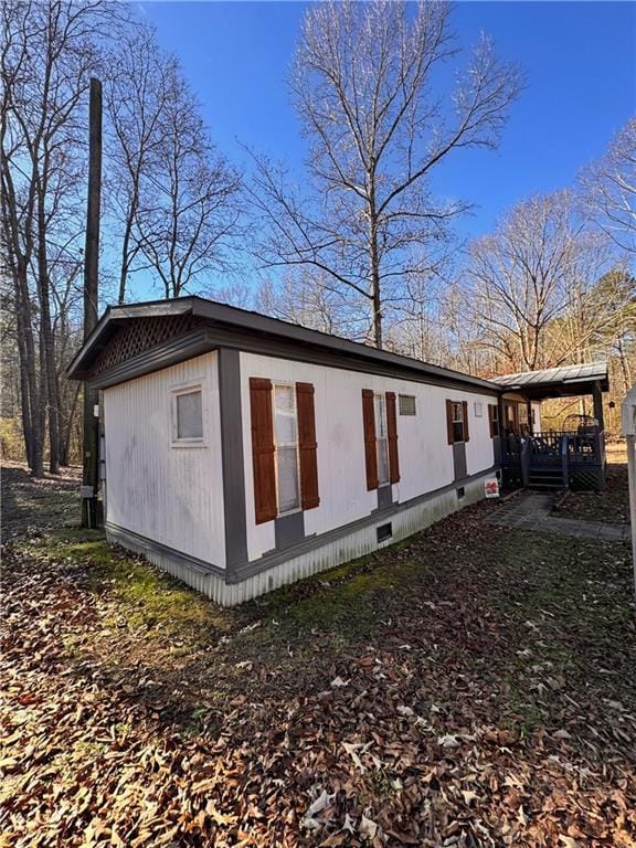 view of side of home featuring a carport