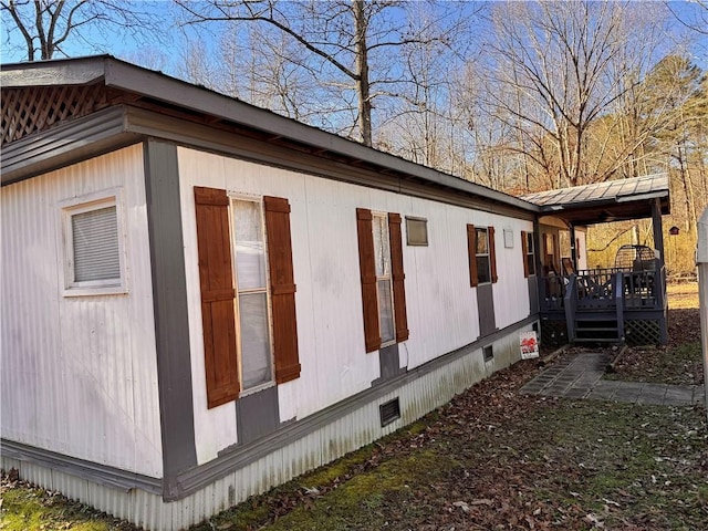 view of home's exterior featuring a wooden deck