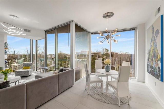 sunroom / solarium featuring a notable chandelier