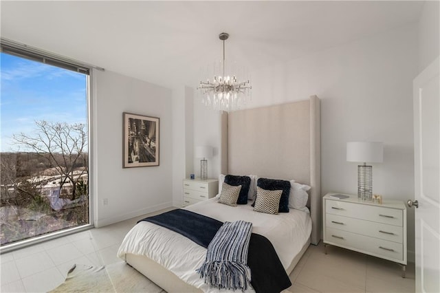 tiled bedroom with an inviting chandelier and floor to ceiling windows