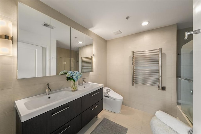 full bathroom with tile patterned floors, radiator heating unit, toilet, and tile walls