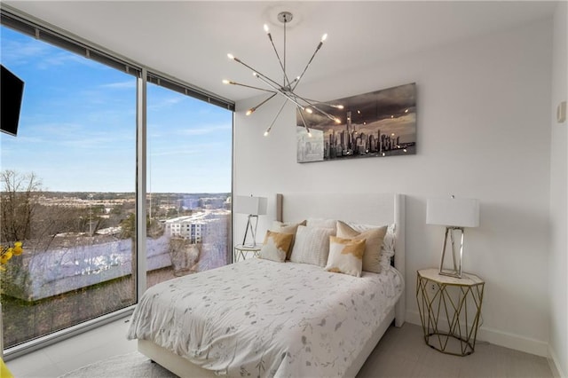 bedroom with a notable chandelier and floor to ceiling windows