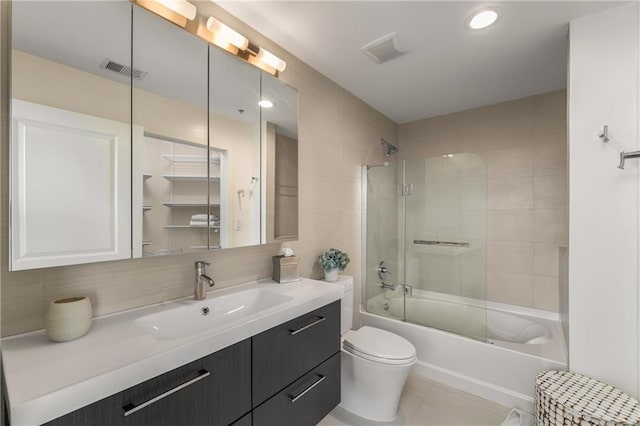 full bathroom featuring backsplash, tile patterned flooring, enclosed tub / shower combo, vanity, and toilet