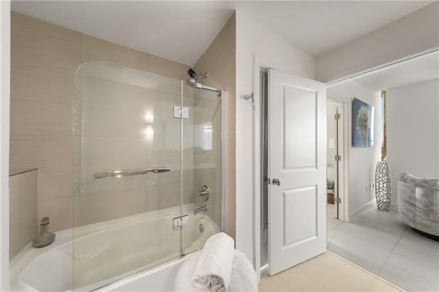 bathroom with tile patterned flooring and bath / shower combo with glass door