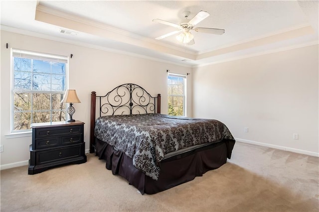 bedroom featuring ceiling fan, a raised ceiling, light carpet, and crown molding