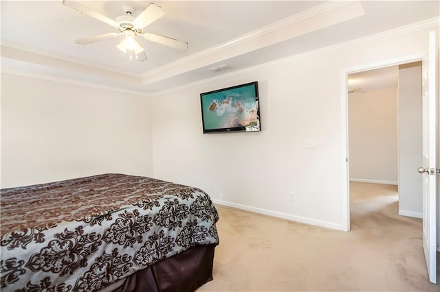 carpeted bedroom with a raised ceiling, ceiling fan, and crown molding