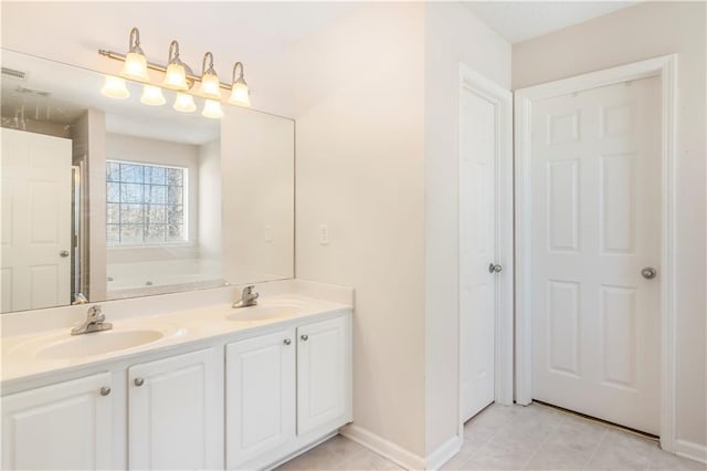 bathroom featuring vanity, tile patterned floors, and a tub