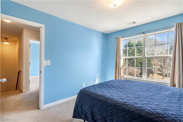 carpeted bedroom with a textured ceiling