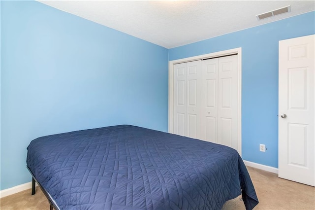 bedroom with light colored carpet and a closet