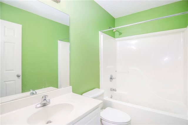 full bathroom with vanity, toilet, a textured ceiling, and bathing tub / shower combination