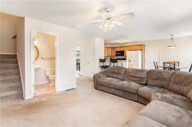 living room featuring ceiling fan and light carpet