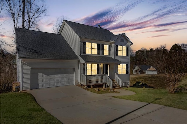 view of front property featuring a yard and a garage