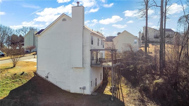 view of side of home featuring a balcony