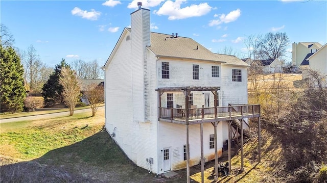 back of house with a lawn, a pergola, and a wooden deck