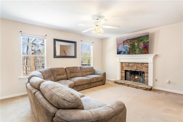 carpeted living room featuring a fireplace, plenty of natural light, and ceiling fan