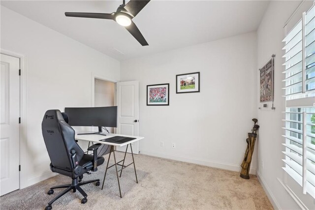 carpeted home office featuring ceiling fan and baseboards