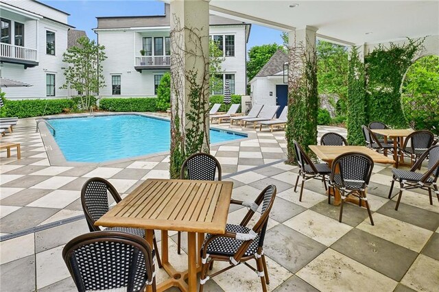 pool featuring outdoor dining area and a patio