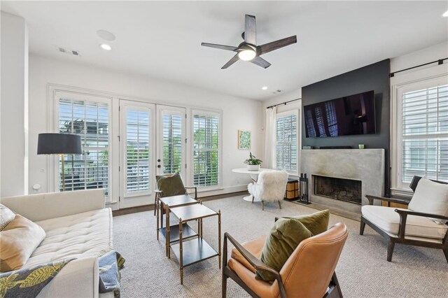 living area featuring a fireplace, a ceiling fan, recessed lighting, and visible vents