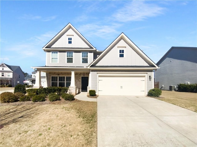 view of front of house with driveway, covered porch, a garage, and board and batten siding
