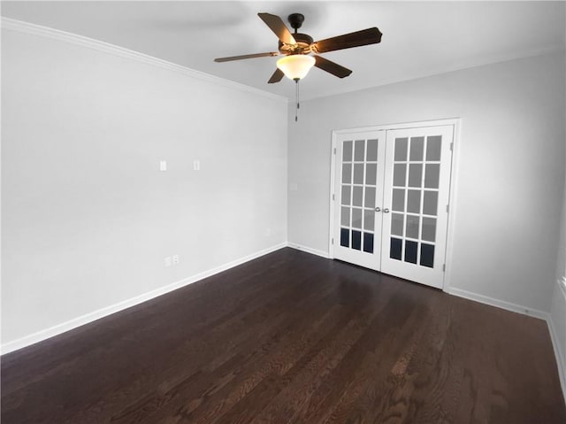 empty room featuring french doors, crown molding, dark wood-type flooring, ceiling fan, and baseboards