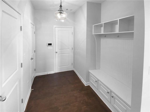 mudroom featuring visible vents, baseboards, a chandelier, and dark wood-type flooring
