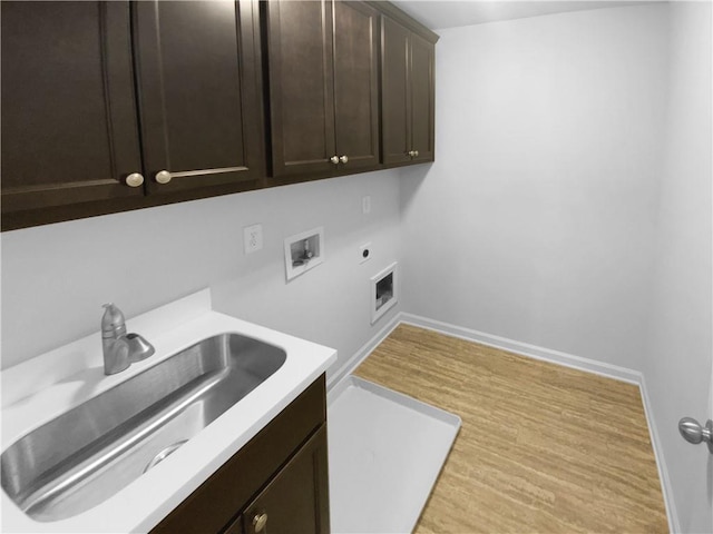 laundry room with washer hookup, cabinet space, a sink, electric dryer hookup, and baseboards