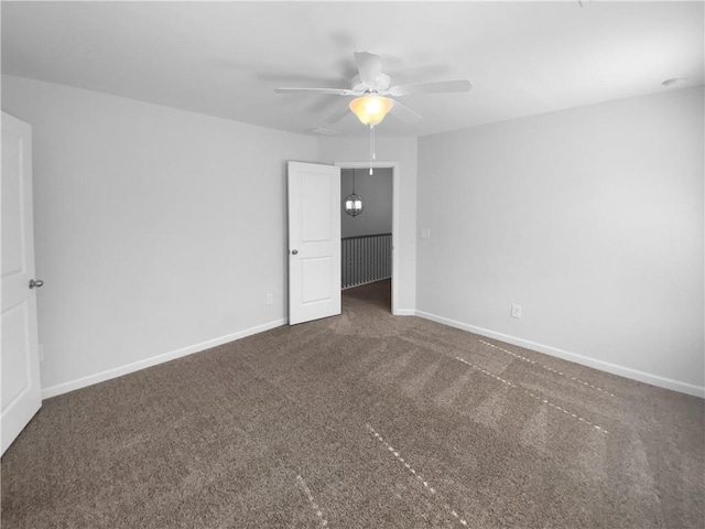 unfurnished bedroom featuring carpet floors, baseboards, and a ceiling fan