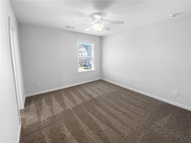 unfurnished room featuring carpet, visible vents, ceiling fan, and baseboards