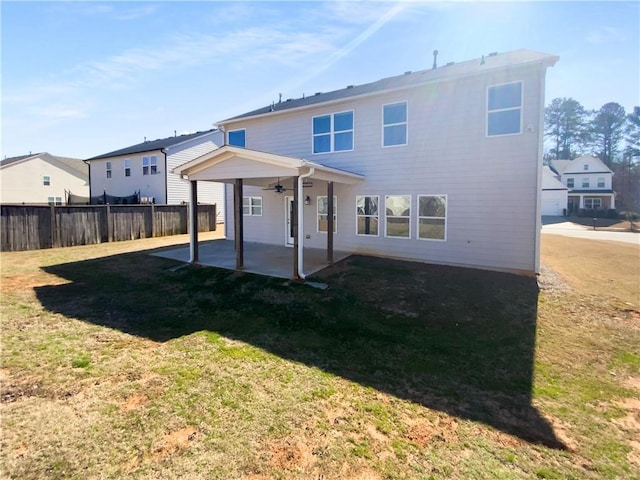 back of property featuring a yard, ceiling fan, fence, and a patio