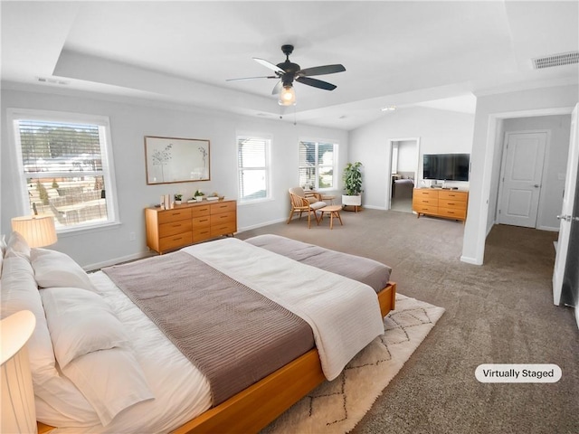 bedroom with a tray ceiling, baseboards, visible vents, and carpet